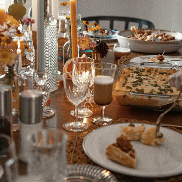 Candles, crystal glasses and a slice of tart down the long table