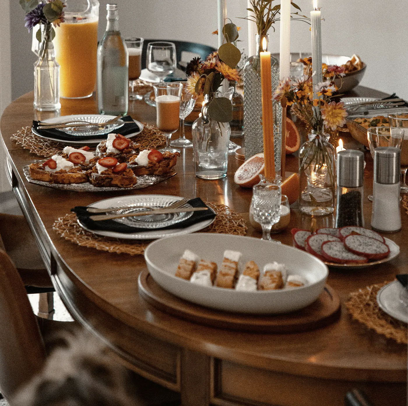 The long table set for lunch, candles and flowers down its length