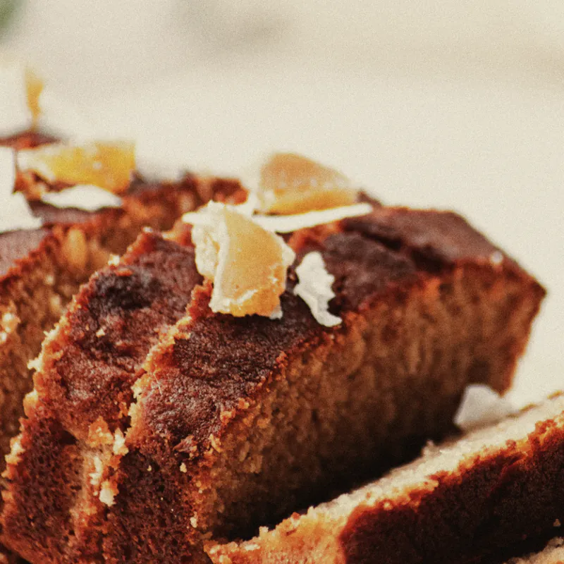 Slices of coconut and ginger loaf cake, toasted coconut on top